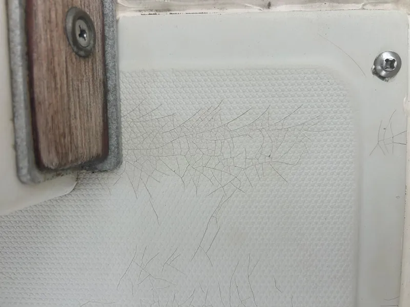 Slide: The Image of Cracked fiberglass detail on 1983 Boston Whaler 25 Outrage boat. - 31