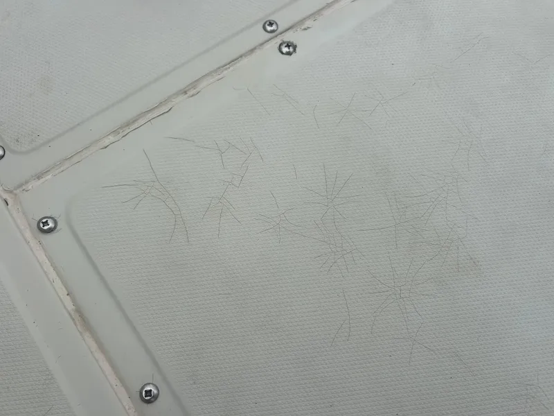 Slide: The Image of Cracks on 1983 Boston Whaler 25 Outrage boat deck surface with visible screws. - 32