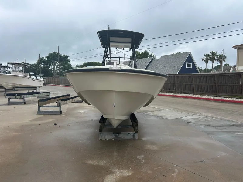 Slide: The Image of 1983 Boston Whaler 25 Outrage boat on trailer, overcast day, residential background. - 6