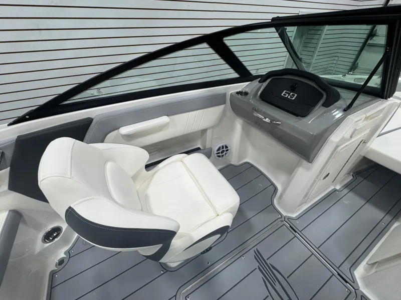 Slide: The Image of 2025 Chaparral 21 SSi boat interior with sleek helm and comfortable seating. - 11