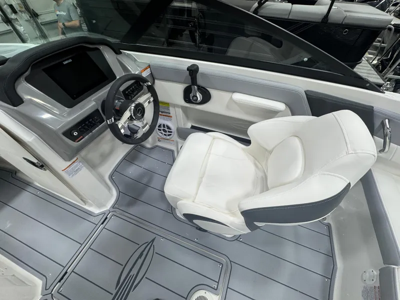 Slide: The Image of 2025 Chaparral 21 SSi boat interior with modern dashboard and comfortable seating. - 14