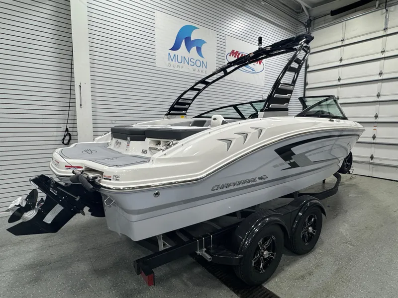 Slide: The Image of 2025 Chaparral 21 SSi boat on trailer in showroom, featuring sleek design and modern features. - 3