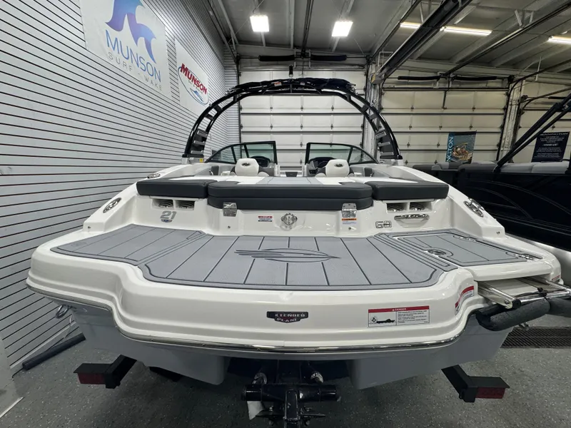 Slide: The Image of 2025 Chaparral 21 SSi boat in showroom, rear view with swim platform. - 4