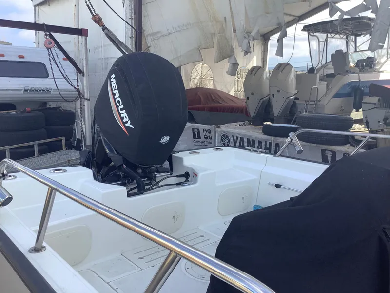 Slide: The Image of 2022 Boston Whaler 170 Montauk with Mercury engine, docked in a marina setting. - 4