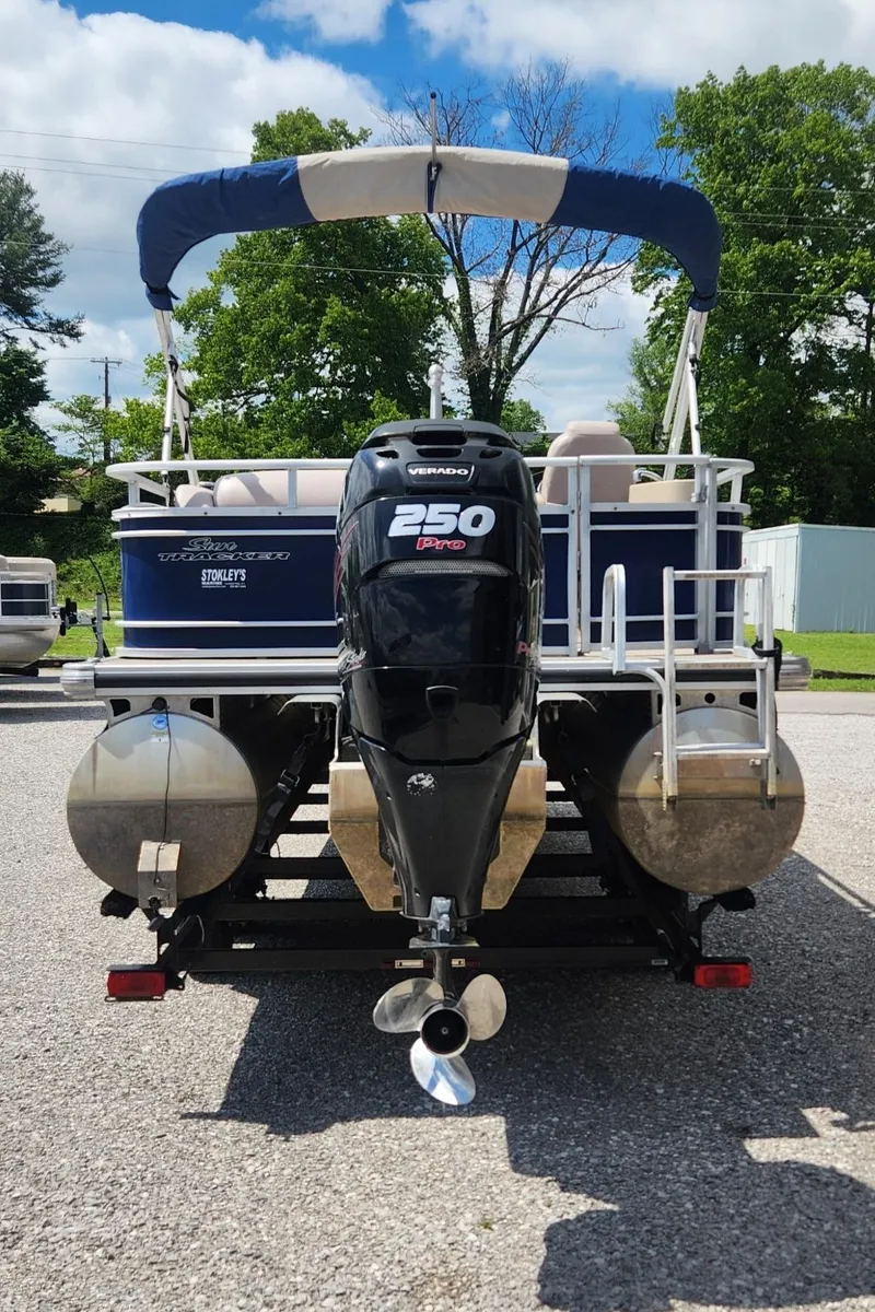 Slide: The Image of 2014 Sun Tracker Regency Edition 254 XP3 pontoon boat with powerful outboard motor, parked outdoors. - 3