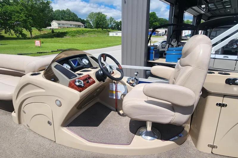 Slide: The Image of 2014 Sun Tracker Regency Edition 254 XP3 boat interior with steering console and captain's chair. - 7