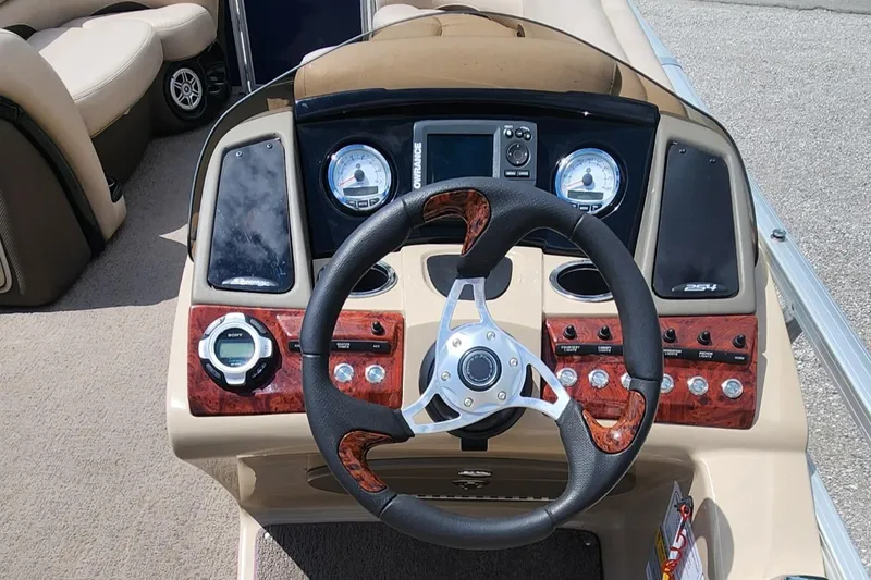 Slide: The Image of 2014 Sun Tracker Regency Edition 254 XP3 boat dashboard with steering wheel and control panel. - 8