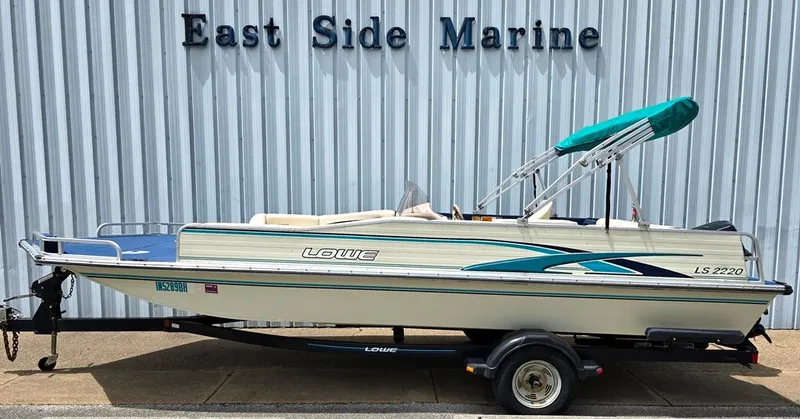 Slide: The Image of 1997 Lowe LS 2220 boat with canopy on trailer at East Side Marine. - 12