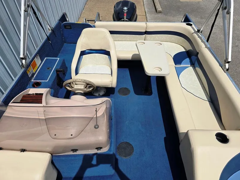 Slide: The Image of 1997 Lowe LS 2220 boat interior with blue carpet and white seating. - 3