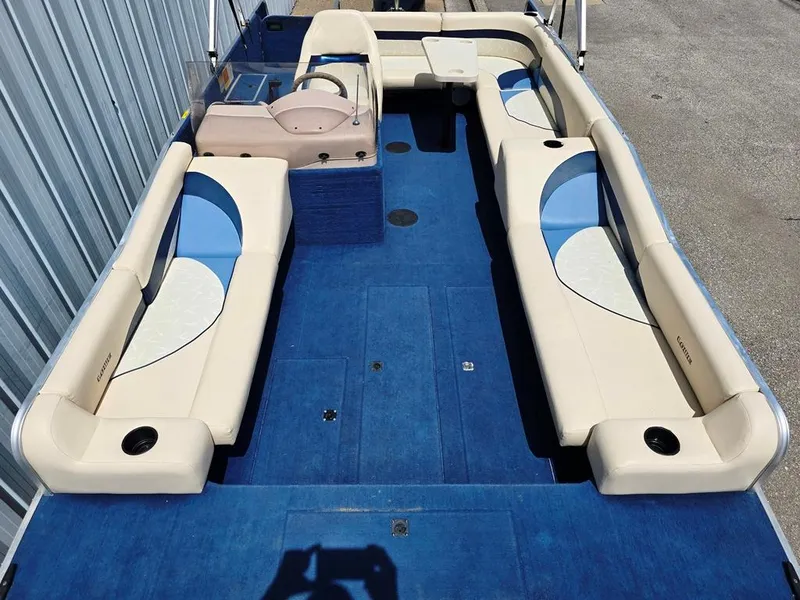 Slide: The Image of 1997 Lowe LS 2220 boat interior with blue carpet and beige seating. - 4
