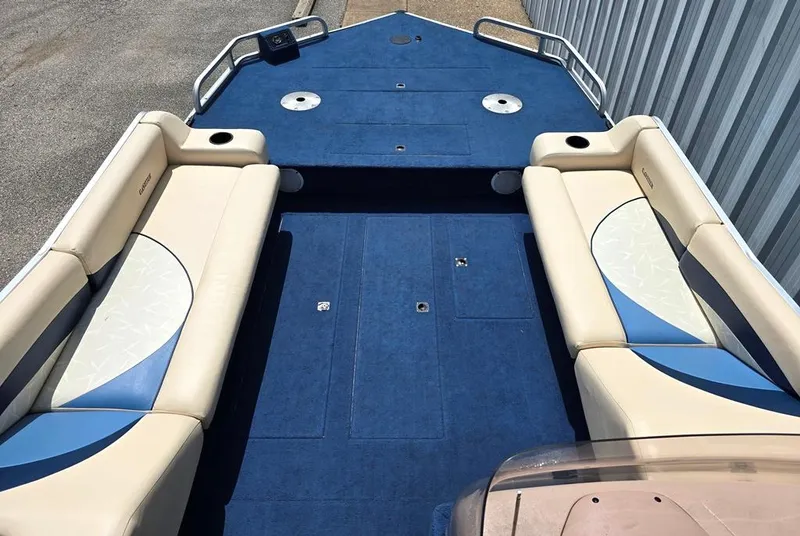 Slide: The Image of 1997 Lowe LS 2220 boat interior with blue and beige seating, spacious deck. - 5