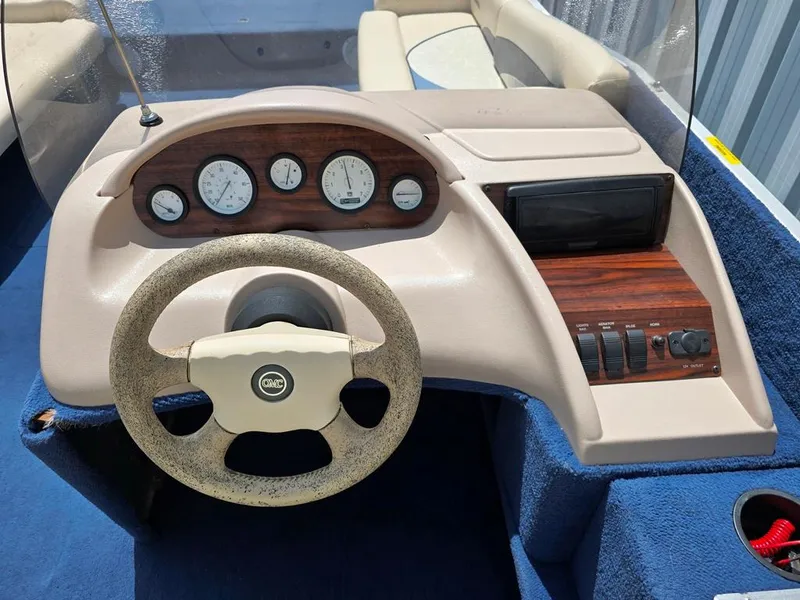Slide: The Image of Steering console of a 1997 Lowe LS 2220 boat with gauges and controls. - 6