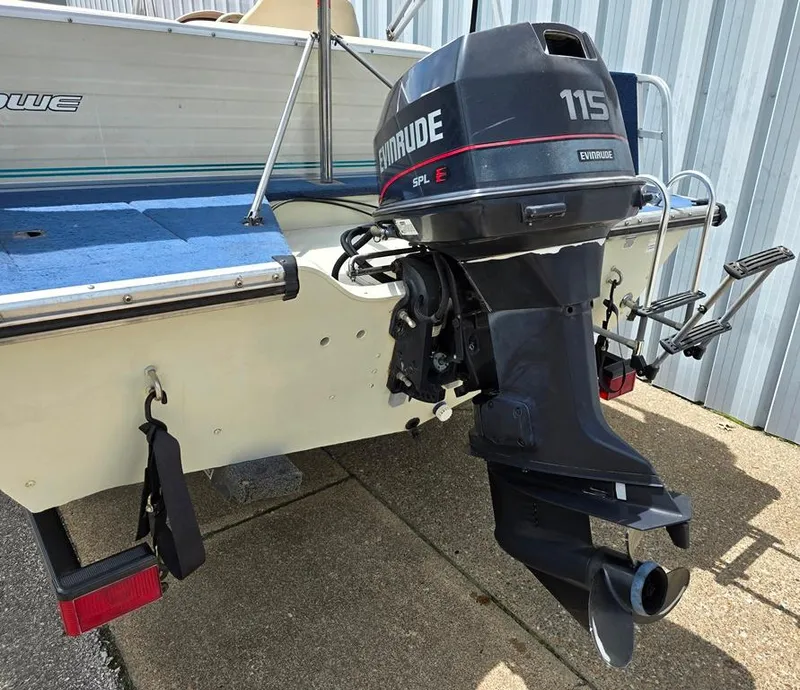 Slide: The Image of 1997 Lowe LS 2220 boat with Evinrude 115 outboard motor, docked on concrete. - 8