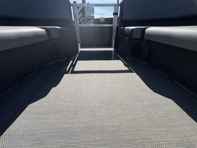 Slide: The Image of Interior view of 2025 Custom Maui 160 Cruise boat, featuring spacious seating and carpeted flooring. - 10