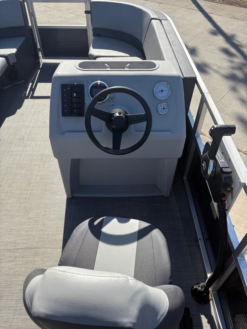 Slide: The Image of 2025 Custom Maui 160 Cruise boat interior with steering wheel and control panel. - 12
