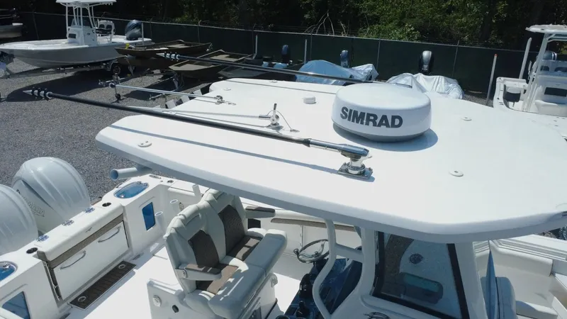 Slide: The Image of 2025 Tidewater 282 CC Adventure boat with Simrad radar, docked in a marina. - 14