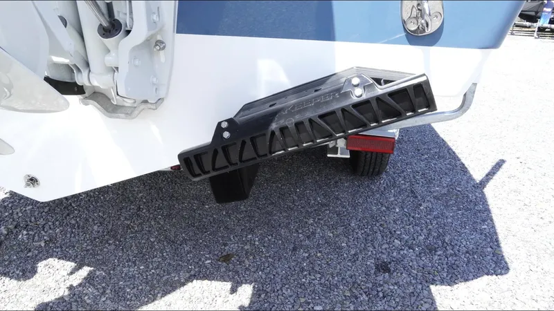 Slide: The Image of 2025 Tidewater 282 CC Adventure boat with trim tab detail on gravel surface. - 15