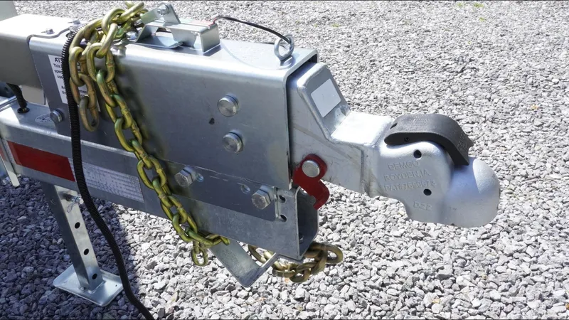 Slide: The Image of Trailer hitch with safety chains on gravel, suitable for 2025 Tidewater 282 CC Adventure. - 18