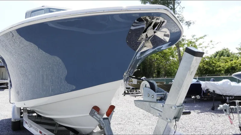 Slide: The Image of 2025 Tidewater 282 CC Adventure boat on trailer, showcasing sleek hull design. - 19