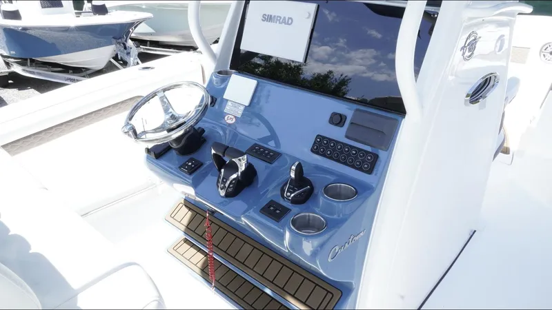 Slide: The Image of 2025 Tidewater 282 CC Adventure boat console with steering wheel and controls. - 20