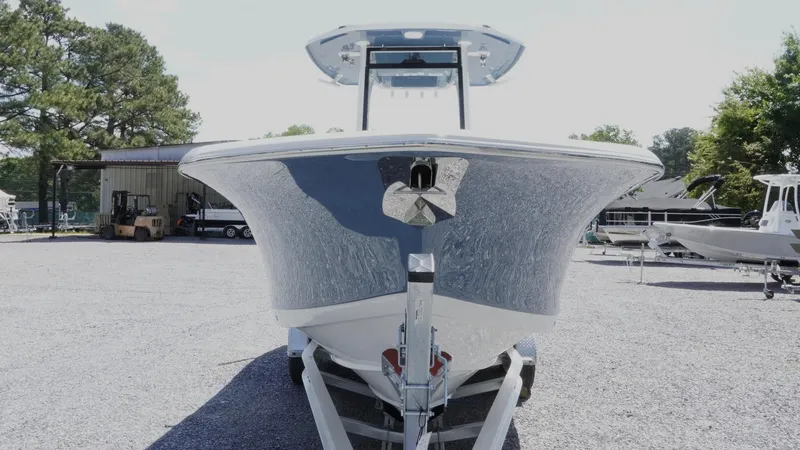 Slide: The Image of 2025 Tidewater 282 CC Adventure boat on trailer, front view, in outdoor setting. - 21