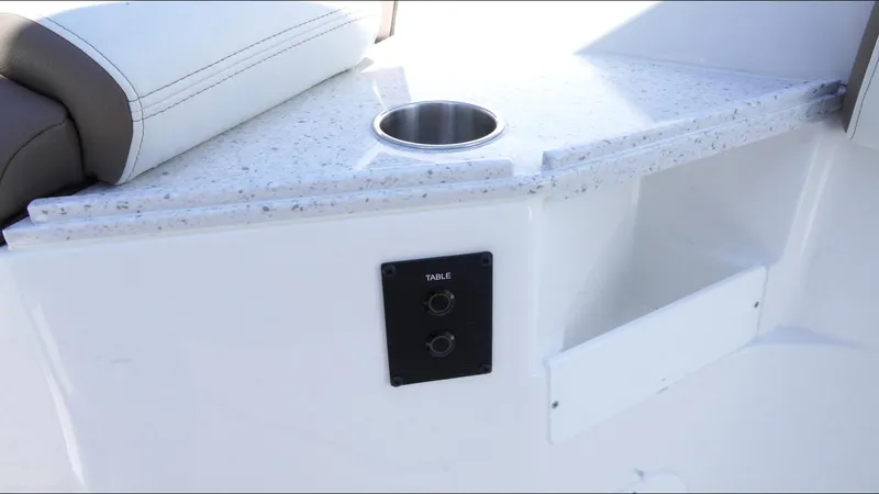 Slide: The Image of 2025 Tidewater 282 CC Adventure boat interior with cup holder and control panel. - 26