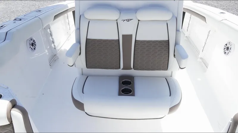 Slide: The Image of 2025 Tidewater 282 CC Adventure boat interior with cushioned seating and cup holders. - 28