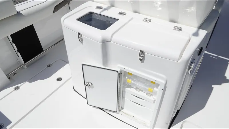 Slide: The Image of 2025 Tidewater 282 CC Adventure boat interior with storage compartments and seating area. - 31