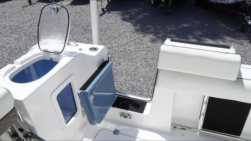 Slide: The Image of 2025 Tidewater 282 CC Adventure boat interior with storage compartments and seating. - 34