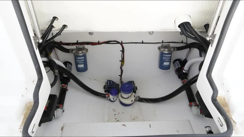 Slide: The Image of 2025 Tidewater 282 CC Adventure boat engine compartment with wiring and filters. - 38