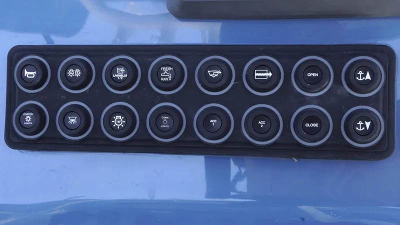 Slide: The Image of Control panel of 2025 Tidewater 282 CC Adventure boat with labeled buttons. - 39