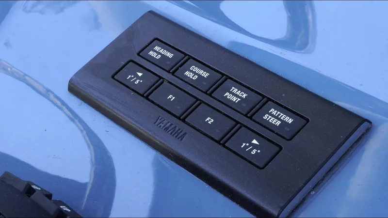 Slide: The Image of Control panel on 2025 Tidewater 282 CC Adventure boat, featuring navigation and steering buttons. - 40