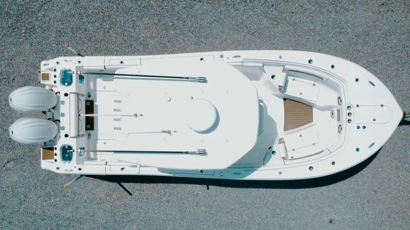 Slide: The Image of 2025 Tidewater 282 CC Adventure boat, aerial view, showcasing sleek design and dual engines. - 7