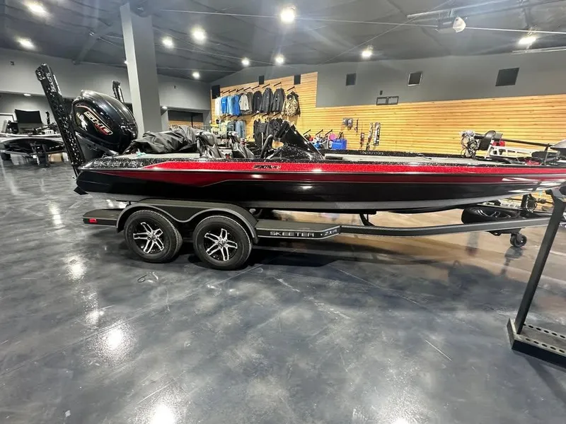 Slide: The Image of 2025 Skeeter ZXR 21 boat in showroom, sleek design with red and black accents. - 4