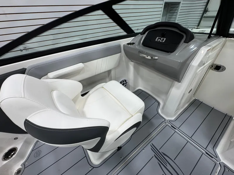 Slide: The Image of 2025 Chaparral 21 SSi boat storage compartment with blue interior and white exterior. - 12