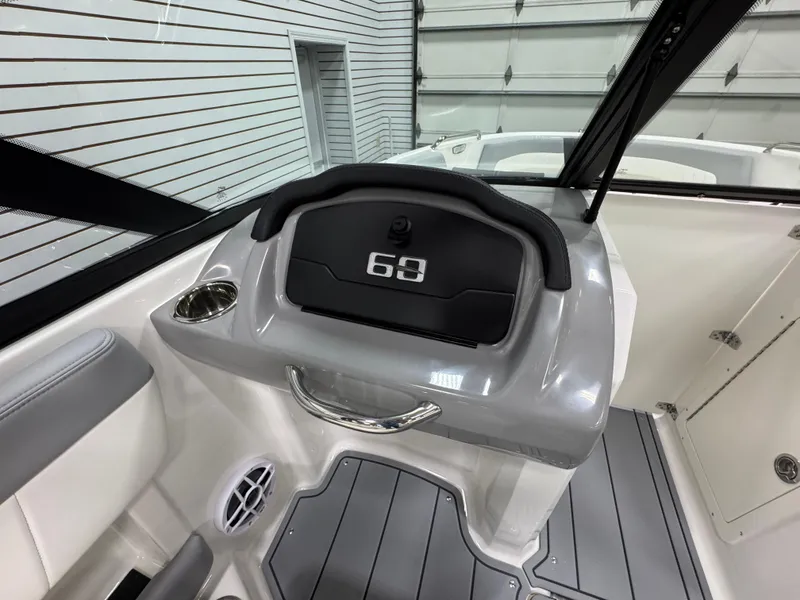 Slide: The Image of 2025 Chaparral 21 SSi boat interior with modern dashboard and comfortable seating. - 13