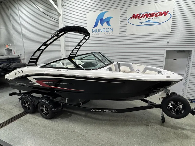 Slide: The Image of 2025 Chaparral 21 SSi boat interior with steering wheel and white captain's chair. - 2