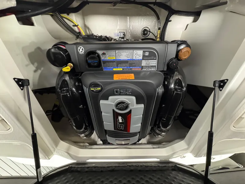 Slide: The Image of Engine compartment of a 2025 Chaparral 21 SSi boat, featuring a powerful motor. - 23