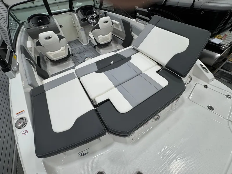 Slide: The Image of 2025 Chaparral 21 SSi boat with ladder and propeller in a garage setting. - 8