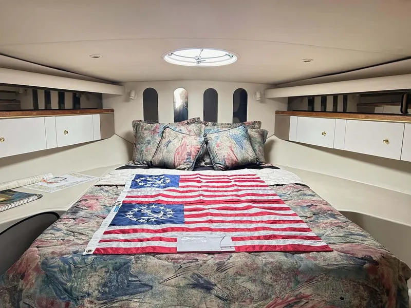 Slide: The Image of Luxurious 1997 Cruisers Yachts 4270 Esprit cabin with American flag-themed bedding. - 13
