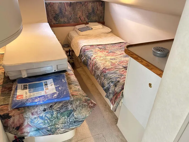 Slide: The Image of 1997 Cruisers Yachts 4270 Esprit cabin with twin beds and colorful bedding. - 14