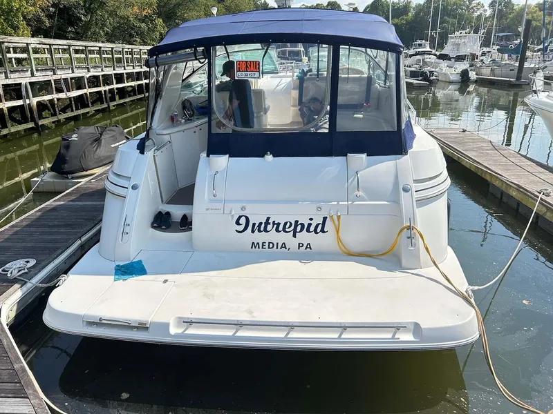 Slide: The Image of 1997 Cruisers Yachts 4270 Esprit docked, named "Intrepid," with blue canopy and marina background. - 18