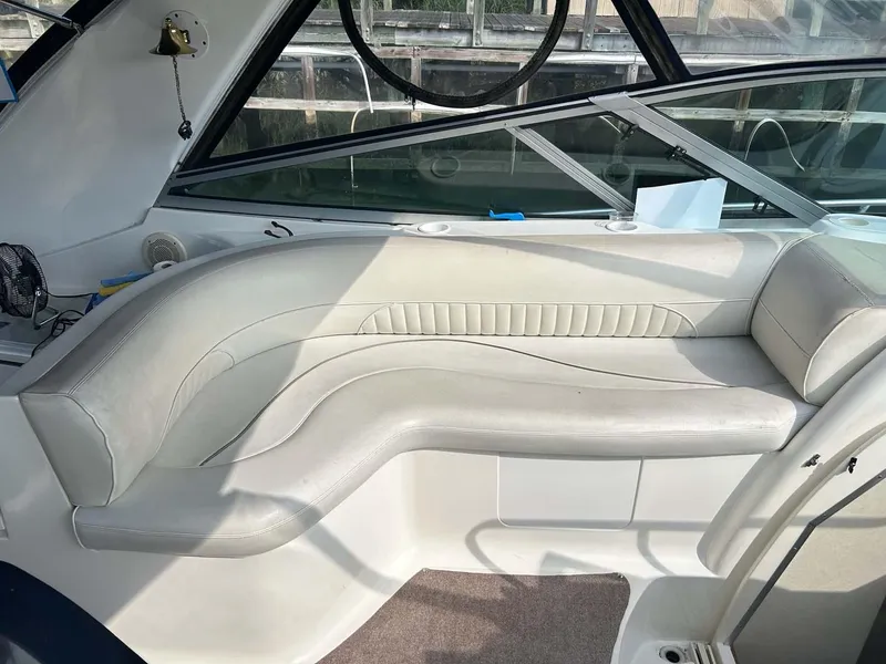 Slide: The Image of 1997 Cruisers Yachts 4270 Esprit interior with curved white seating and large windows. - 7