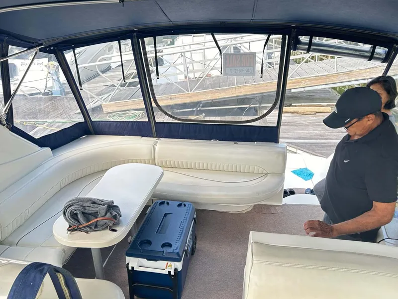 Slide: The Image of Interior of 1997 Cruisers Yachts 4270 Esprit with seating and table, docked at marina. - 8