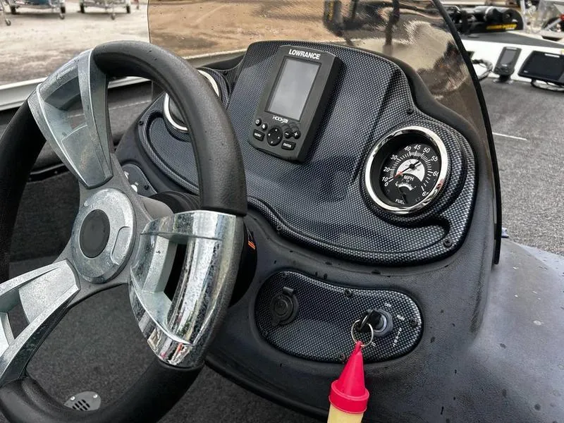 Slide: The Image of 2017 Lowe Stinger 175 dashboard with steering wheel, gauges, and Lowrance fish finder. - 10
