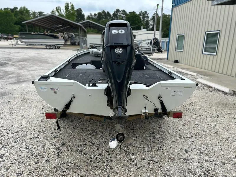 Slide: The Image of 2017 Lowe Stinger 175 boat with 50 HP outboard motor, parked on gravel. - 3