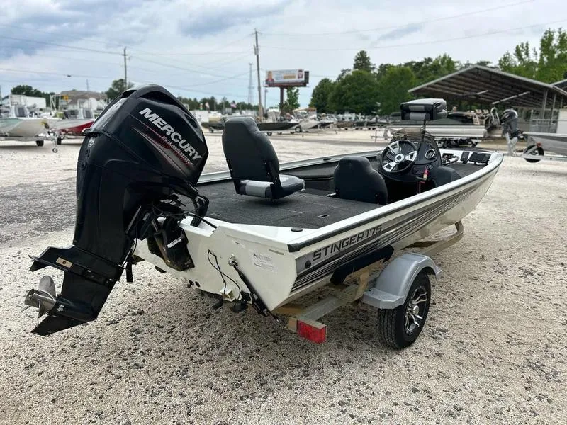 Slide: The Image of 2017 Lowe Stinger 175 boat with Mercury engine on a trailer, parked outdoors. - 5