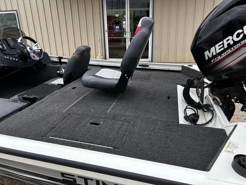 Slide: The Image of 2017 Lowe Stinger 175 boat with Mercury engine, featuring spacious deck and seating. - 8