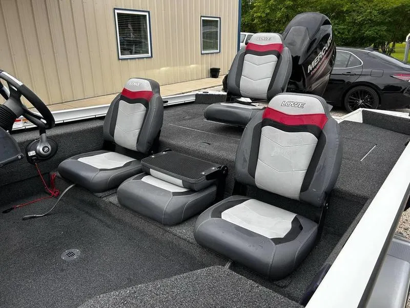 Slide: The Image of 2017 Lowe Stinger 175 boat interior with gray and red seating, Mercury engine visible. - 9