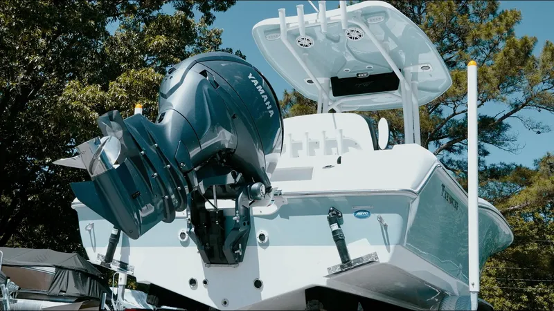 Slide: The Image of 2025 Tidewater 210 LXF boat with Yamaha engine, rear view, outdoors. - 13